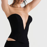close-up of a woman's torso wearing a black strapless corset top with a deep plunging neckline