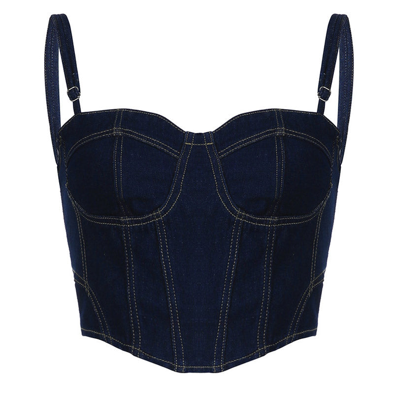 Woman posing in a dark blue denim corset top and denim shorts.