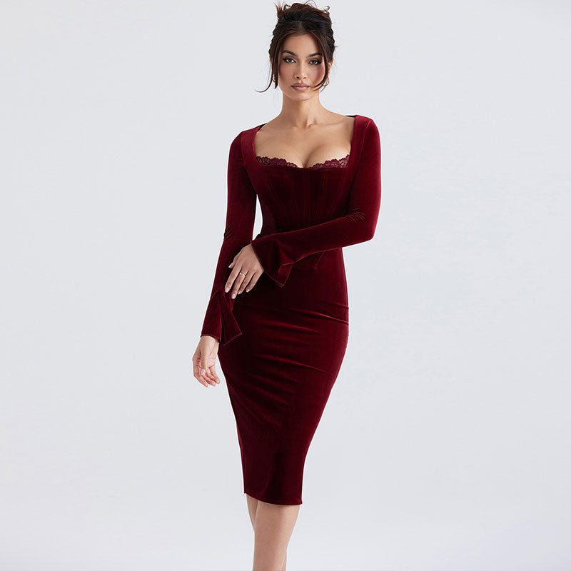 Woman wearing a burgundy velvet midi dress with long bell sleeves and a square neckline.