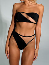 woman wearing a black strapless bikini with sheer cut-outs