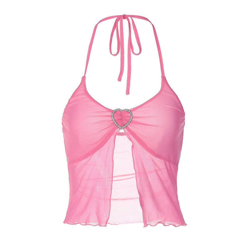 Close-up of a woman's chest showing a pink halter neck cropped top with a heart-shaped embellishment