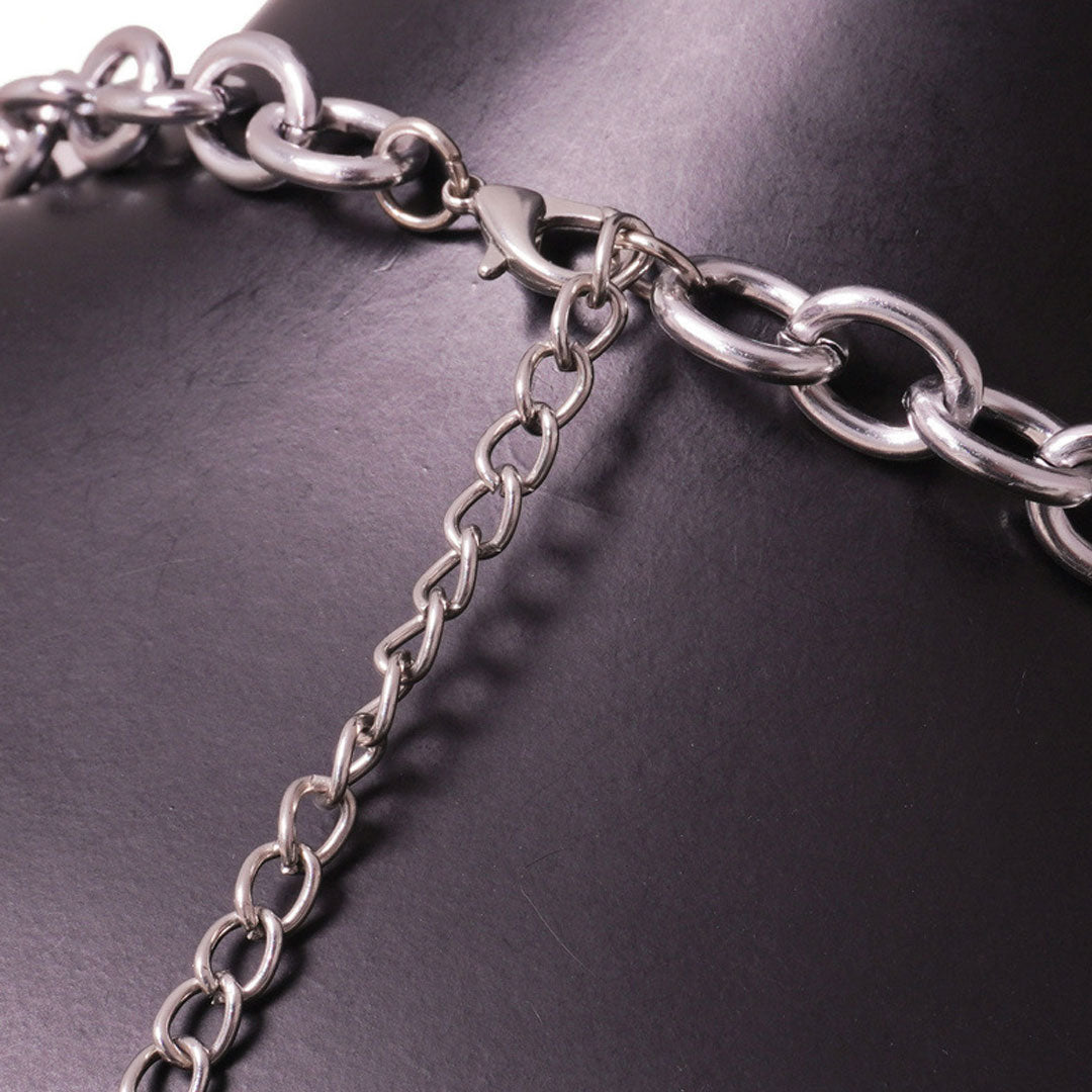 Close-up of the silver chain and clasp closure of the halter top