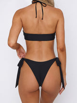 Front view of a black bikini with halter neck and ring details
