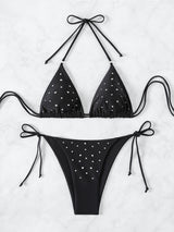 Black bikini top and bottom with silver embellishments laid flat