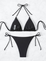 Back view of a black bikini top and bottom laid flat