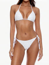 Woman wearing a white sequined bikini