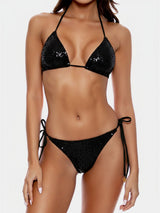 Woman wearing a black sequined bikini