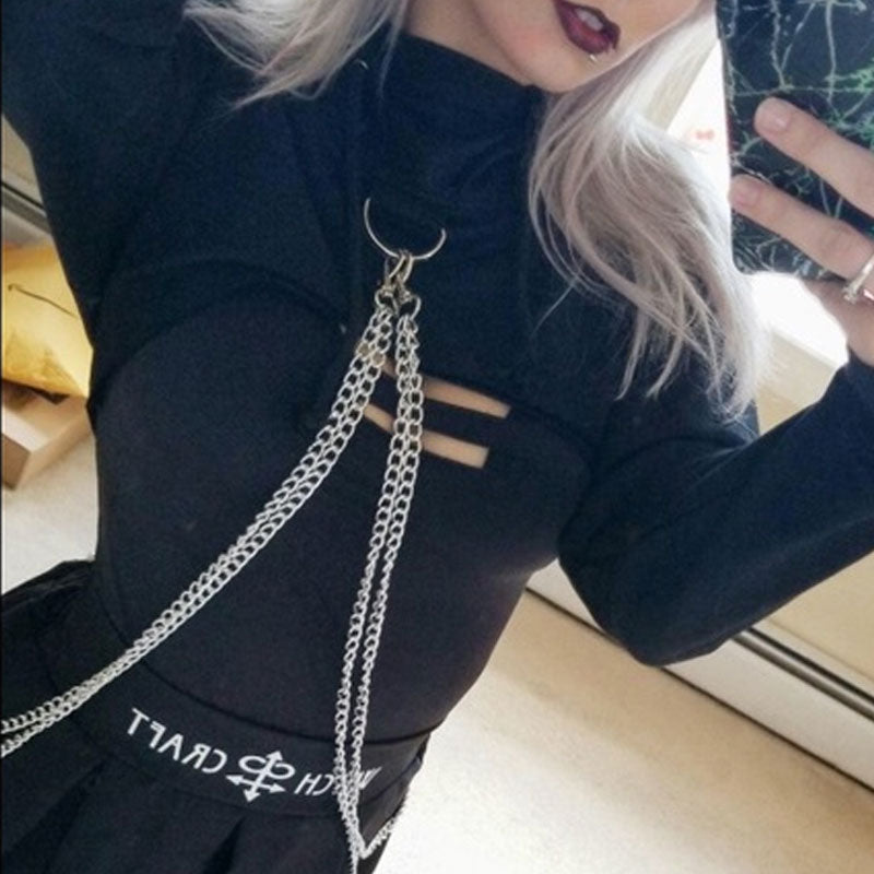 woman wearing a black top with chains