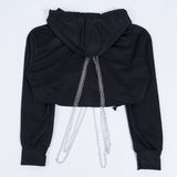 back of a black cropped hoodie with chains