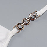 Close-up of a gold chain detail on a white garment strap.