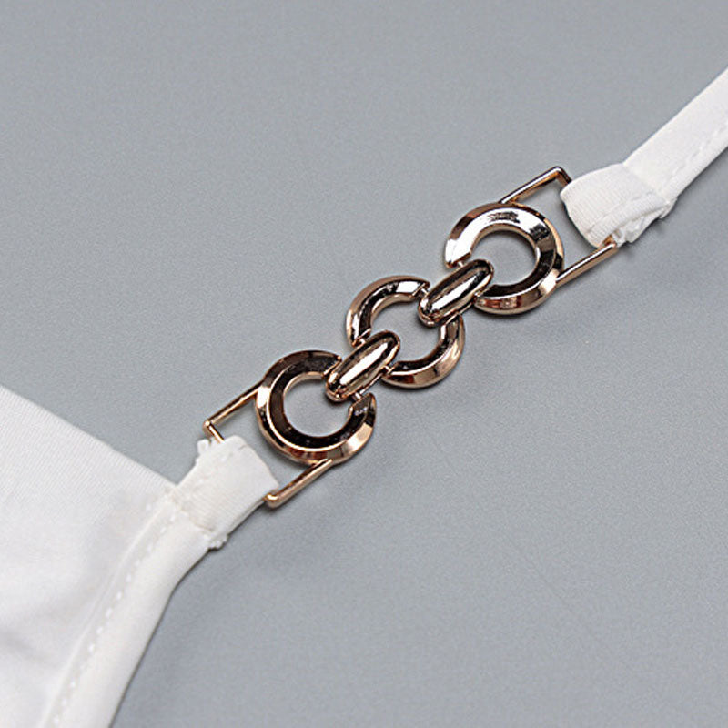 Close-up of the gold chain detail on a white halter top