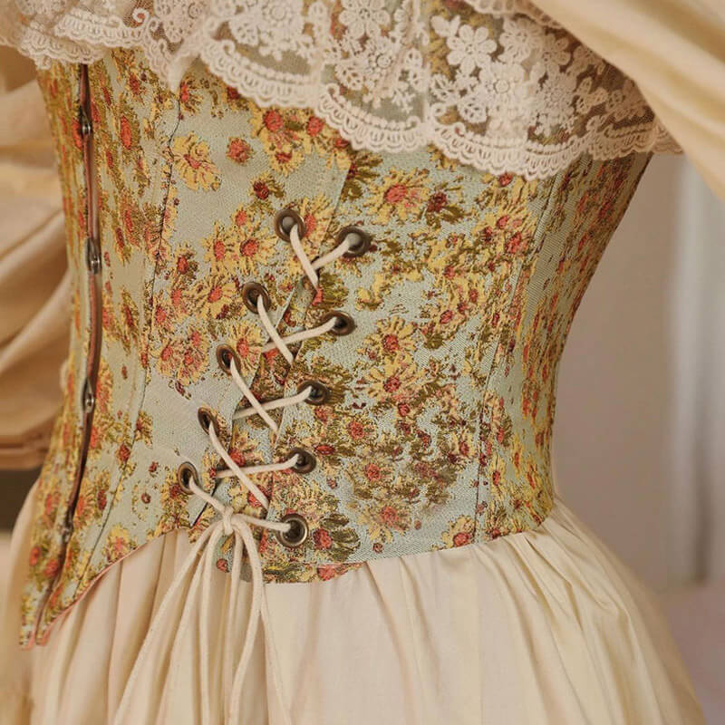 Detail of a floral corset with cream ribbon lacing and grommets.
