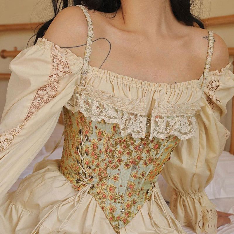 Woman wearing a cream off-the-shoulder blouse with lace trim and a floral corset.