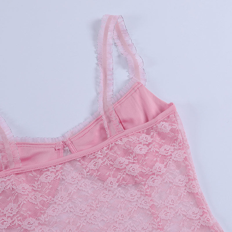 Close-up of the shoulder strap of a pink lace top, showing ruffled trim.