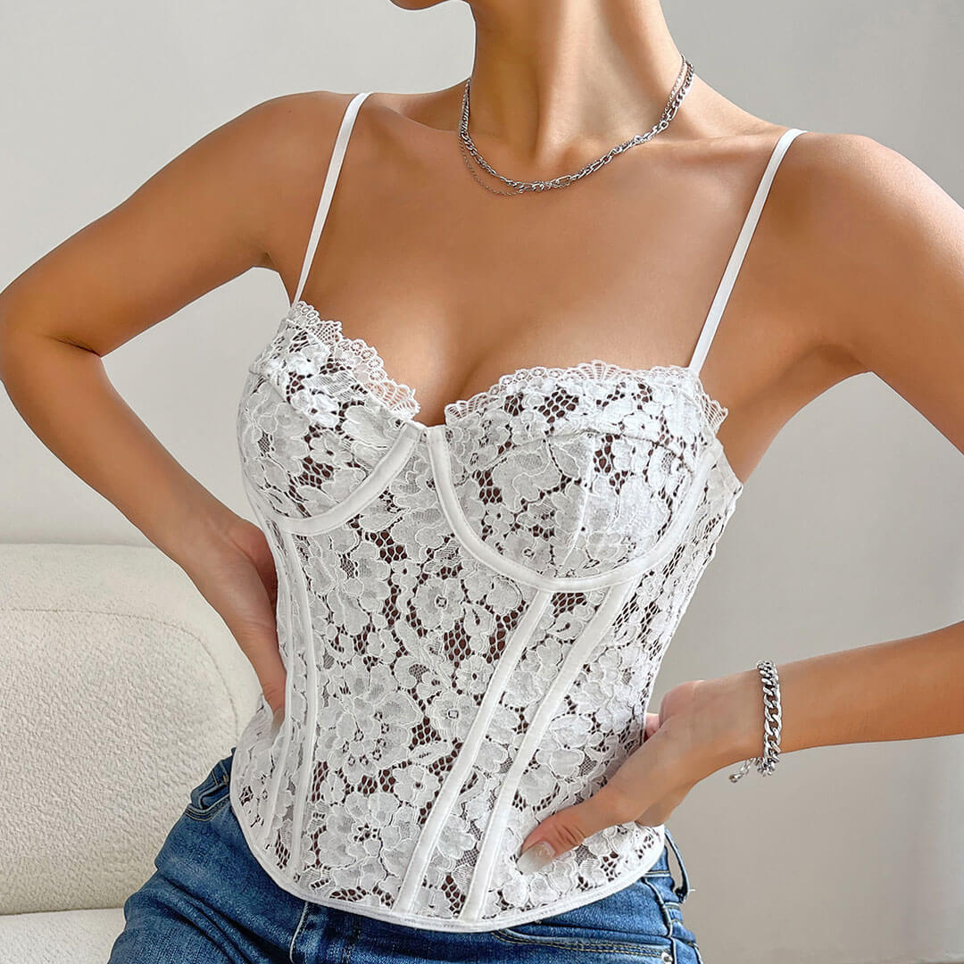 Close-up of a woman in a white lace corset top, showing the intricate details of the lace.