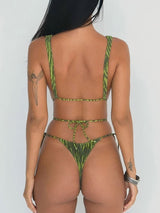woman in a green and black striped bikini from the back