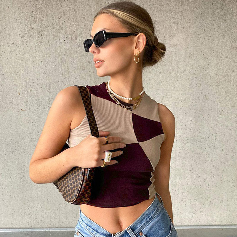 Close-up of a woman wearing a maroon and beige geometric print cropped top and sunglasses.