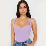 woman wearing a purple corset top and blue jeans, front view