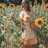 Woman in a floral dress standing in a sunflower field