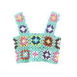 A mint green crochet crop top with colorful floral granny squares and scalloped edges, shown flat against a white background.