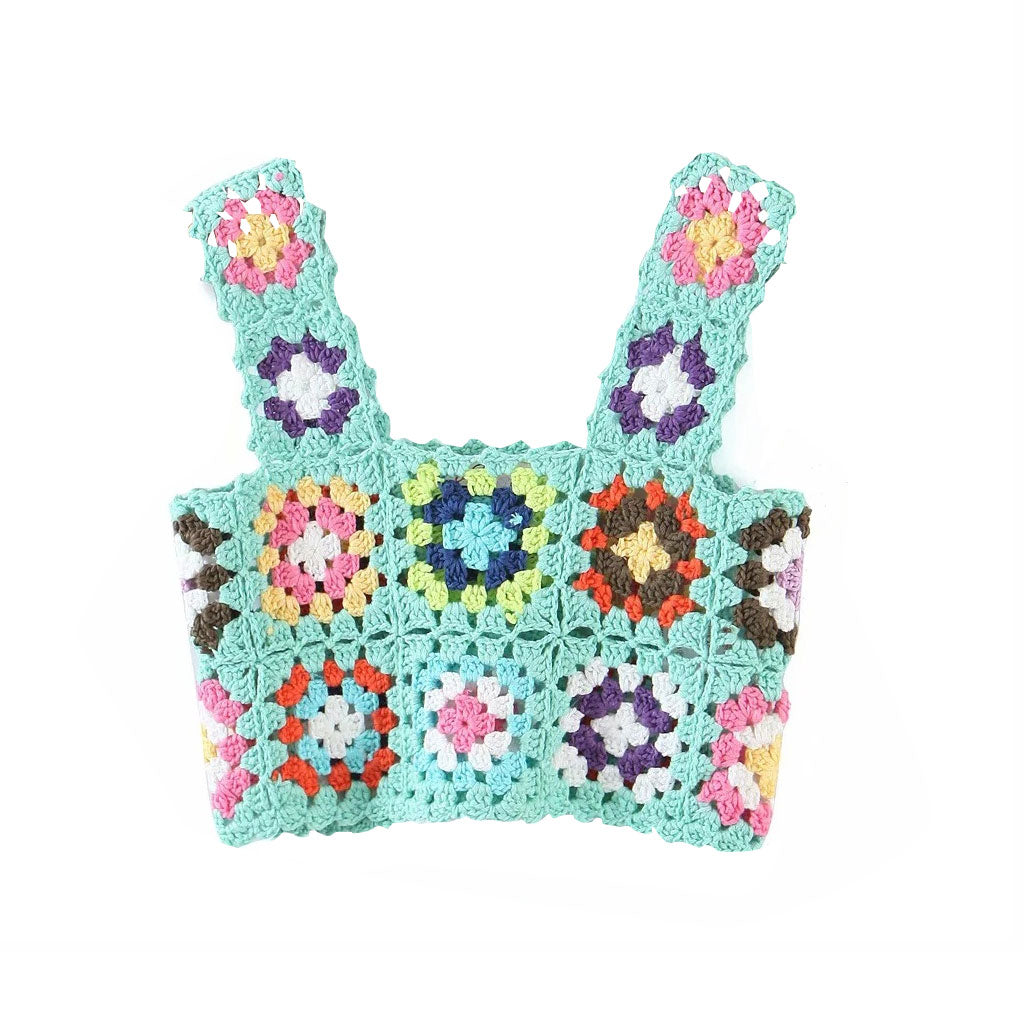A mint green crochet crop top with colorful floral granny squares and scalloped edges, shown flat against a white background.