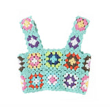 A mint green crochet crop top with colorful floral granny squares and scalloped edges, shown flat against a white background.
