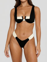 front view of a woman wearing a black and beige bikini
