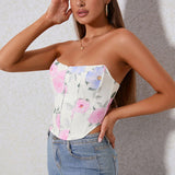 Close-up of a woman's torso showing a strapless floral corset top.