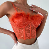 Woman showing off jewelry while wearing an orange lace corset top.